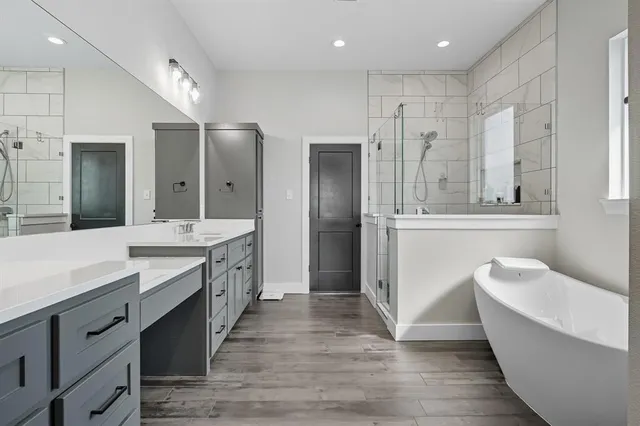 an empty space with wooden floor and kitchen view
