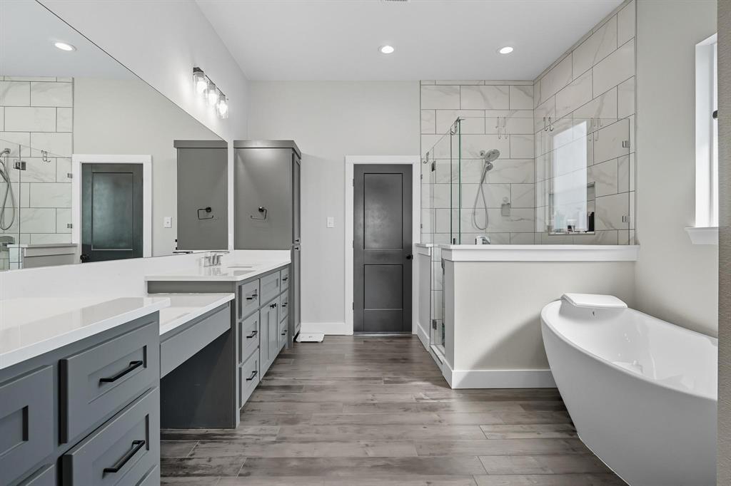 6502 Randy Avenue Abilene, TX 79606 - Photo 15 of 37 a large bathroom with a double vanity sink a large mirror and a shower