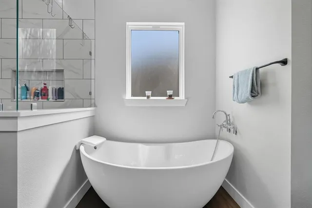 a large bathroom with a double vanity sink a large mirror and a shower