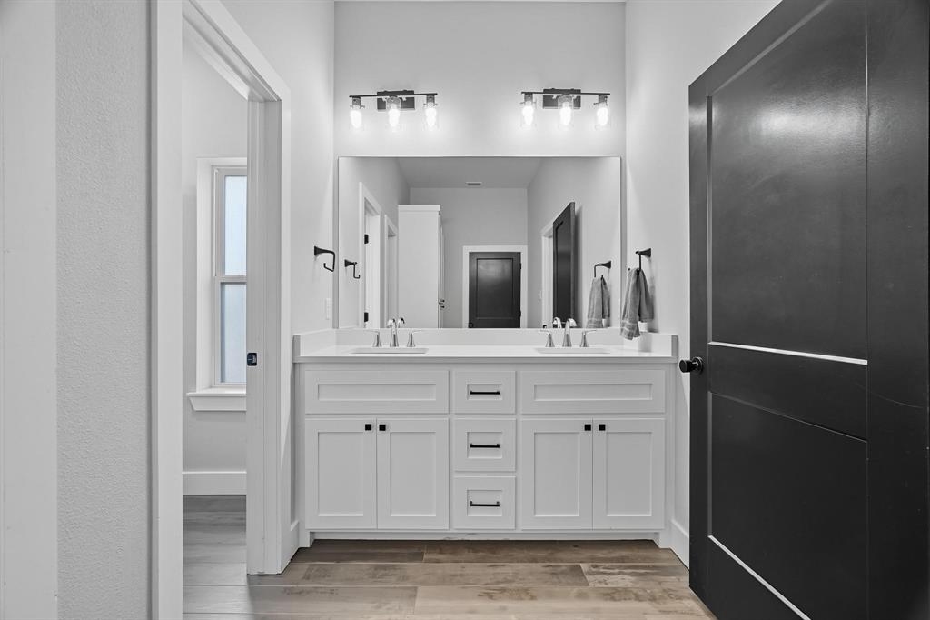 6502 Randy Avenue Abilene, TX 79606 - Photo 20 of 37 a bathroom with a double vanity sink and a mirror