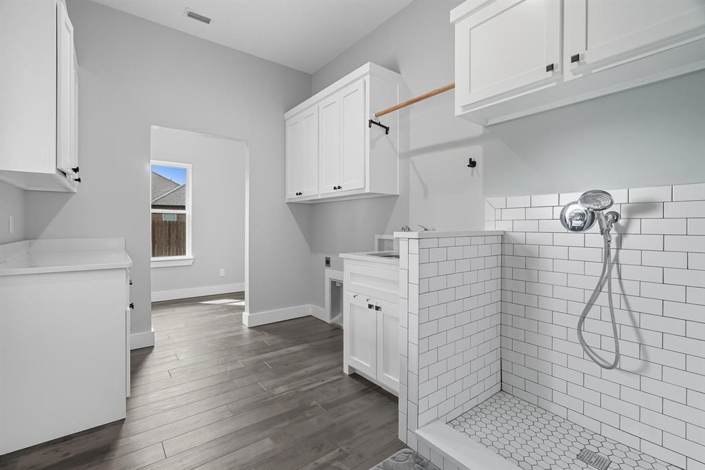 6502 Randy Avenue Abilene, TX 79606 - Photo 27 of 37 a kitchen with cabinets and wooden floor