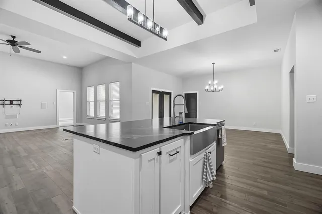 a front view of a house with a garden and yard