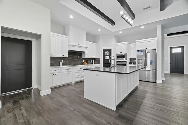 a kitchen with granite countertop a sink and stove