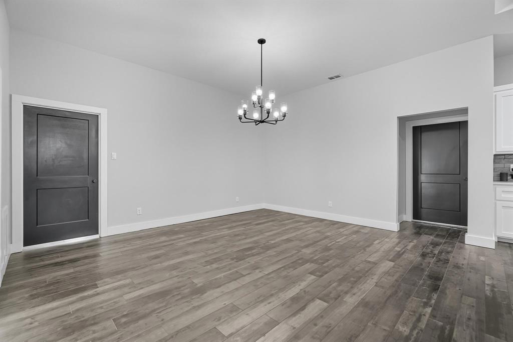6502 Randy Avenue Abilene, TX 79606 - Photo 7 of 37 a view of a room with wooden floor and chandelier