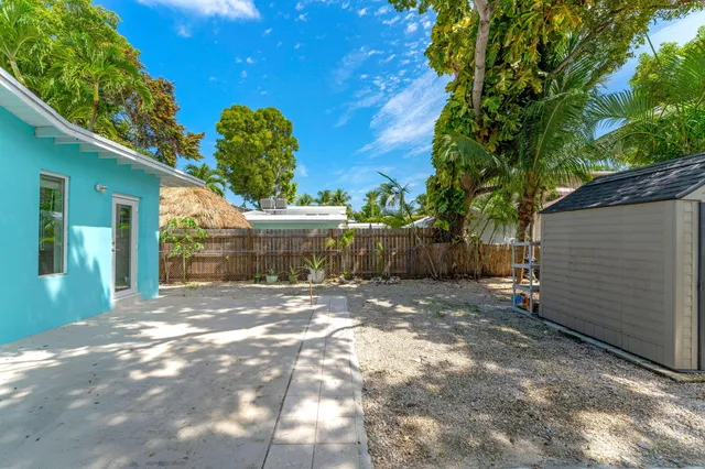 a backyard of a house with table and chairs