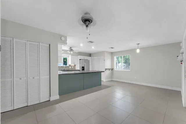 a kitchen with kitchen island granite countertop a stove sink and microwave