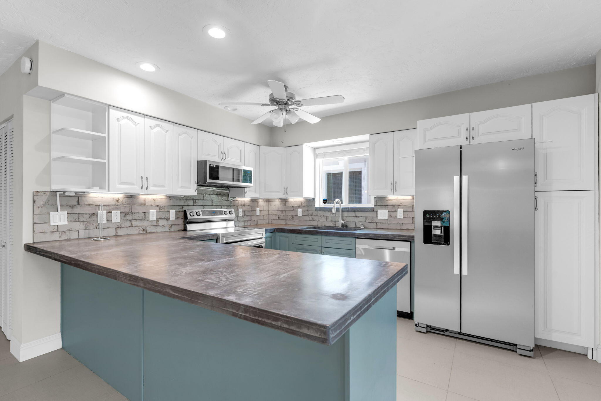 67 Jewfish Avenue Key Largo, FL 33037 - Photo 7 of 43 a kitchen with stainless steel appliances granite countertop a refrigerator a sink a stove a microwave and island