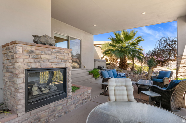 2376 Stone Crest Circle St. George, UT 84790 - Photo 50 of 61 View of patio featuring an outdoor stone fireplace and an outdoor living / dining area
