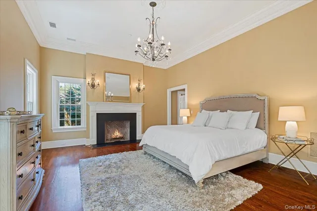 a spacious bedroom with a bed and a fireplace