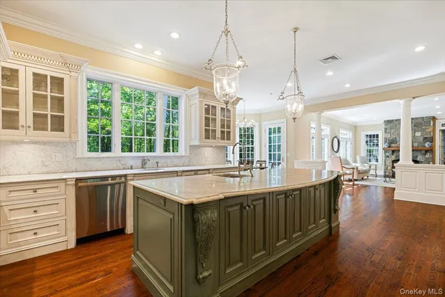 a kitchen with stainless steel appliances granite countertop a sink a stove and a wooden floors