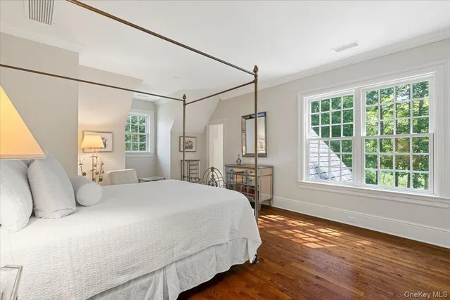 a bedroom with a large bed and a large window