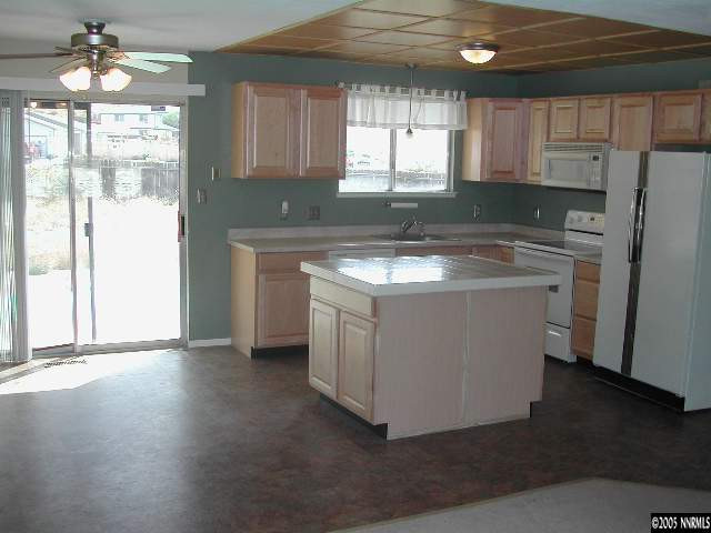 25 Ouzel Way Reno, NV 89508 - Photo 2 of 8 a kitchen with a stove a sink and a refrigerator