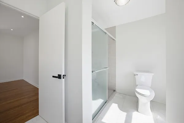 a view of an empty room with wooden floor