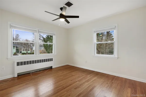 a spacious bedroom with a bed a couch and a window