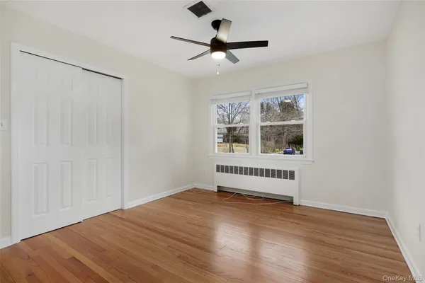 a spacious bedroom with a bed and a chandelier