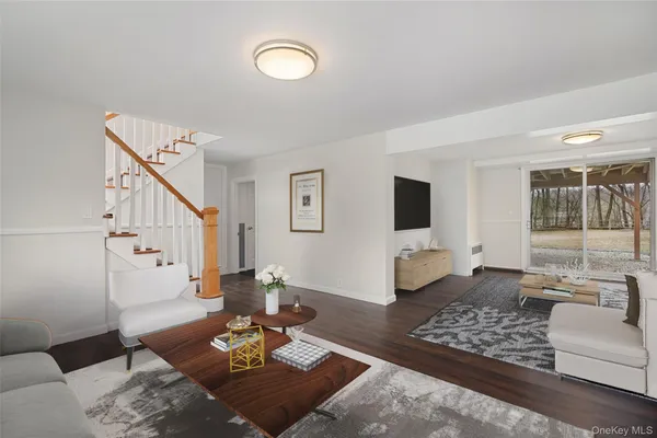 a view of a room with wooden floor and white walls