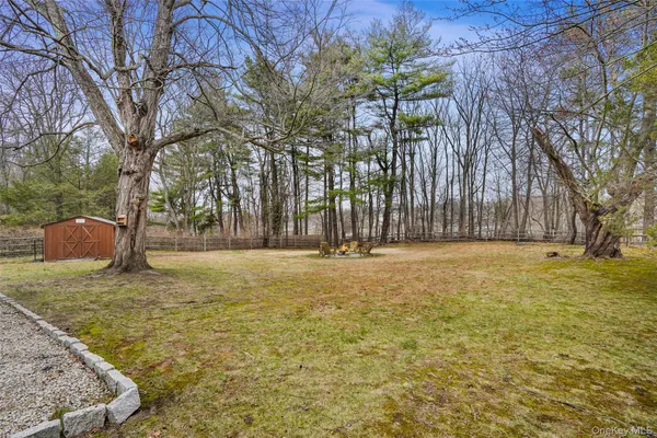 a bathroom with a toilet a sink a mirror and a window