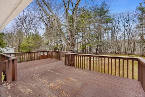 a view of balcony with wooden floor and fence