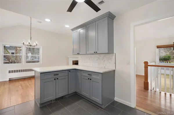 a kitchen with a sink window and cabinets