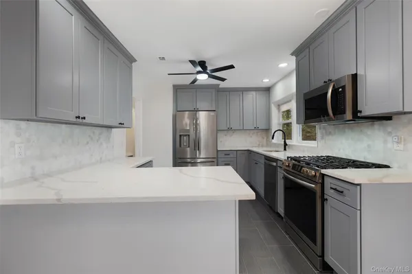 a kitchen with stainless steel appliances a sink stove and refrigerator