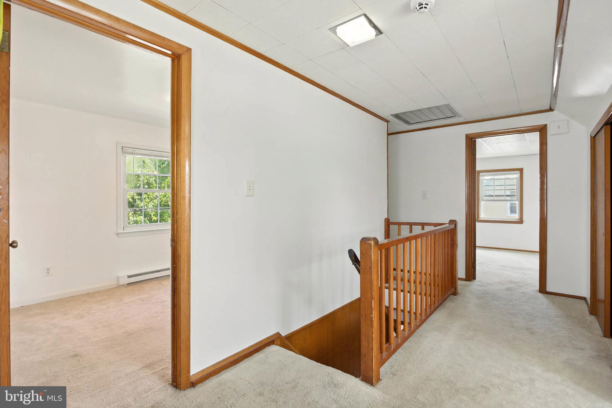 56 Ridgemoor Road Essex, MD 21221 - Photo 19 of 27 a view of a hallway with wooden floor and windows