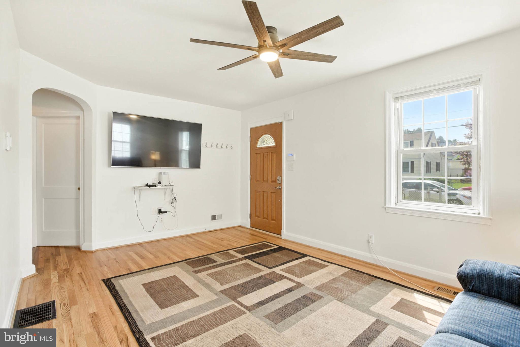 56 Ridgemoor Road Essex, MD 21221 - Photo 3 of 27 a bedroom with a bed and a flat screen tv