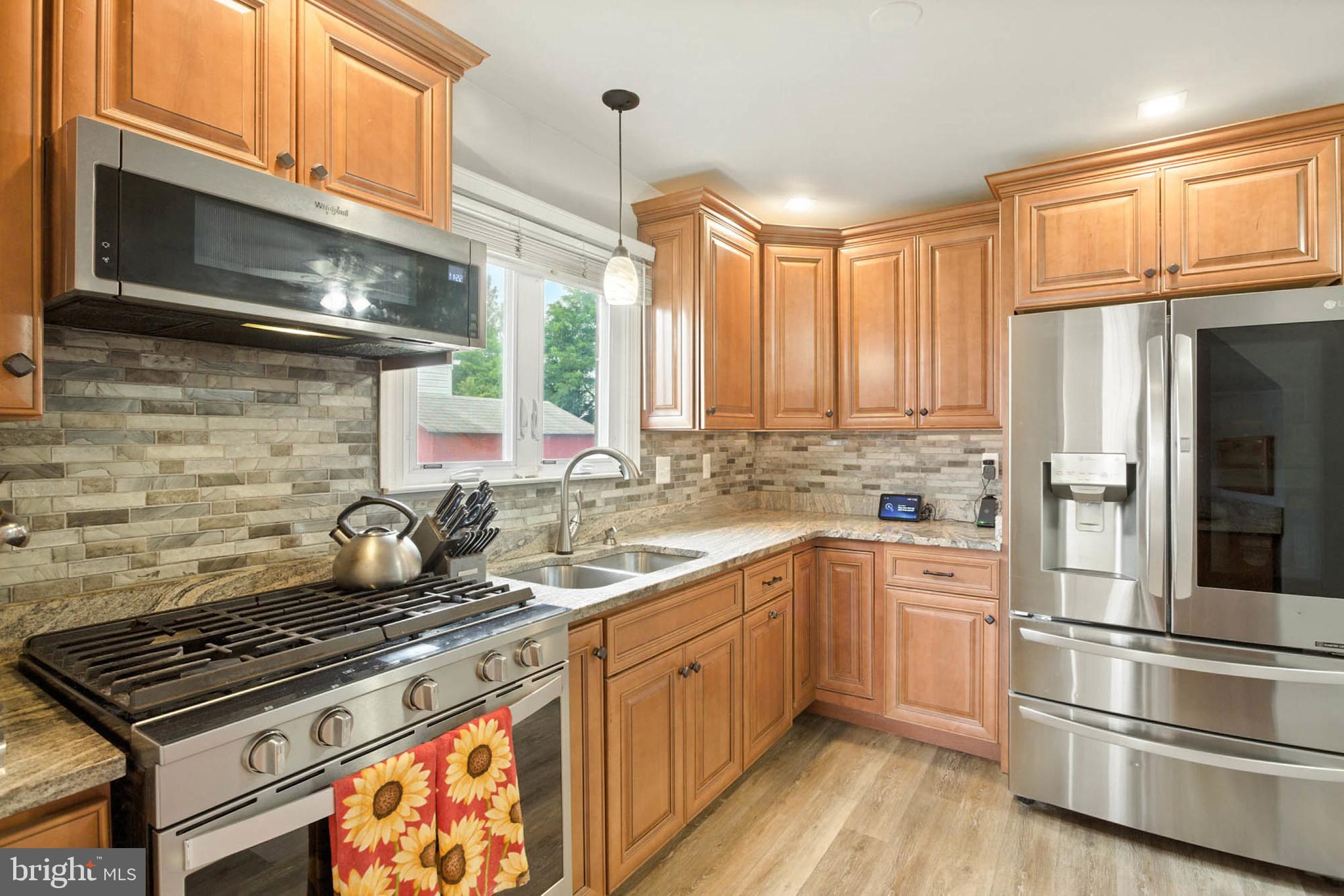 56 Ridgemoor Road Essex, MD 21221 - Photo 6 of 27 a kitchen with a stove a sink and a refrigerator