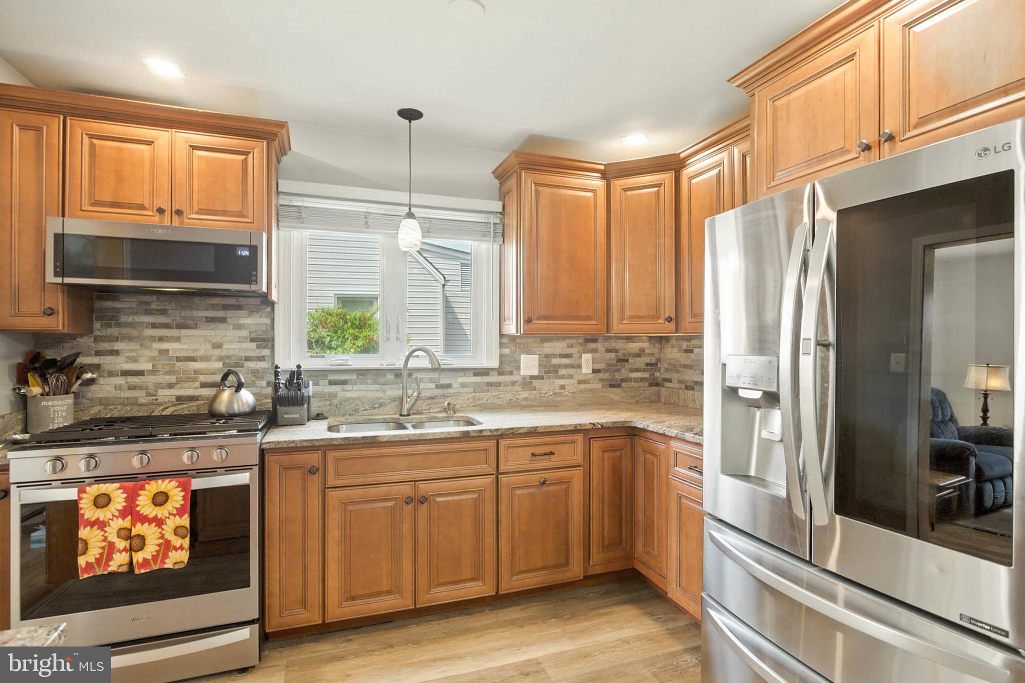 56 Ridgemoor Road Essex, MD 21221 - Photo 7 of 27 a kitchen with a sink stove and refrigerator