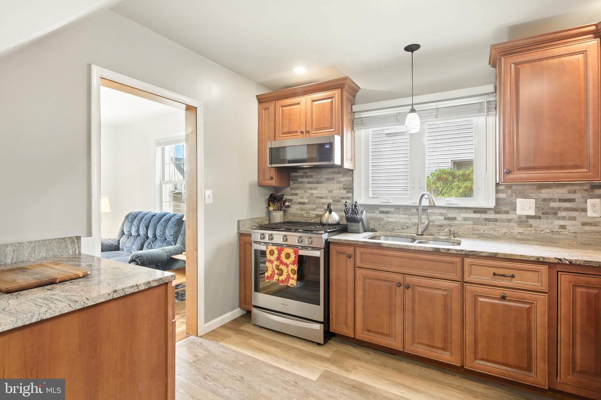 56 Ridgemoor Road Essex, MD 21221 - Photo 8 of 27 a kitchen with granite countertop kitchen island and stainless steel appliances