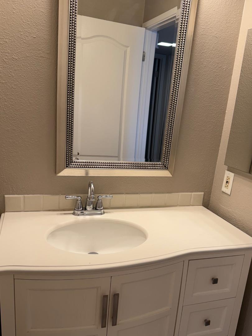 311 Bean Creek Road, Unit 305 Scotts Valley, CA 95066 - Photo 7 of 11 a bathroom with a sink and a mirror