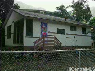 47-501 Ahuimanu Road, Unit G Kaneohe, HI 96744 - Photo 1 of 1 a front view of a house with a yard