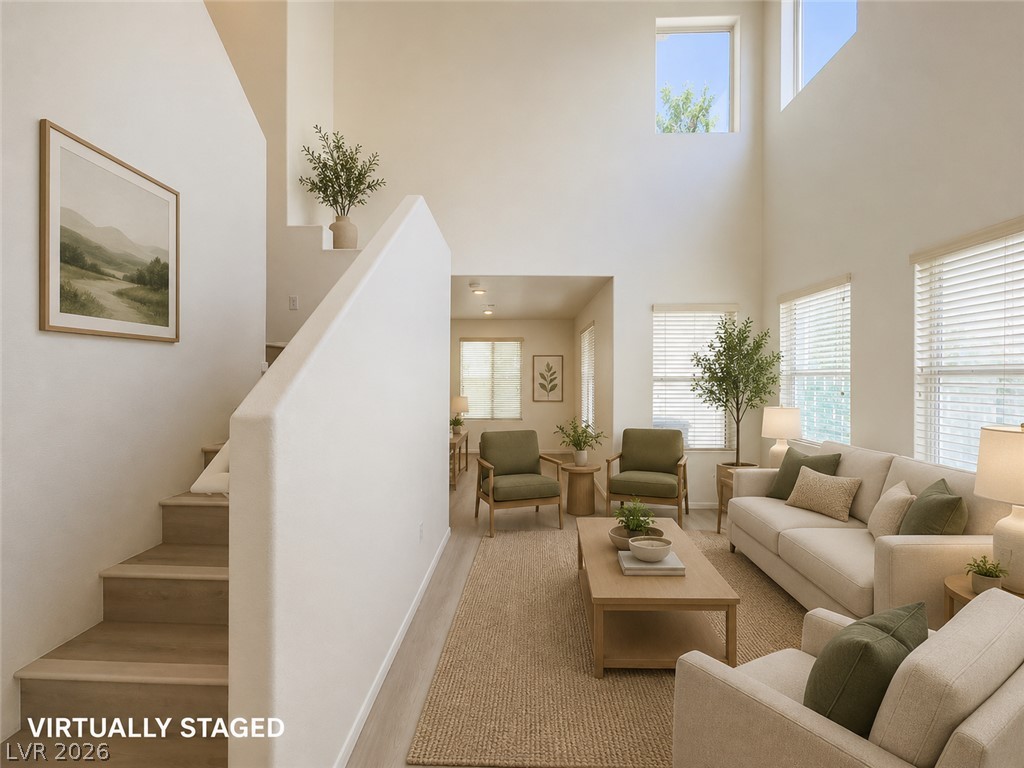 9456 Grandview Spring Avenue Las Vegas, NV 89166 - Photo 2 of 49 Virtually Staged. Grand ceilings and abundant natural light create an inviting atmosphere in this open-concept living area.