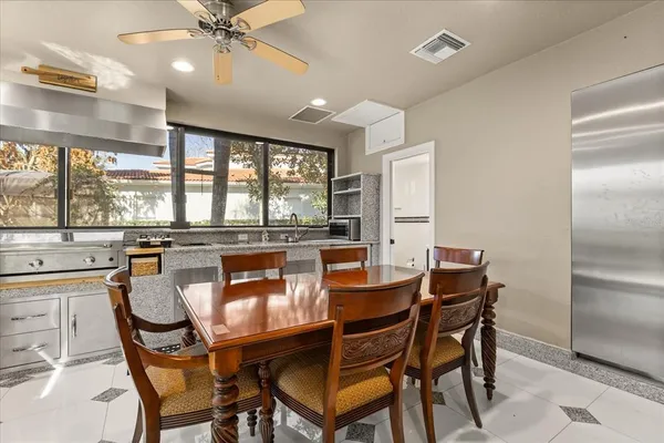 a view of a a dining room with furniture window and wooden floor