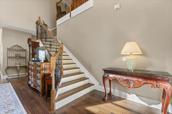 a view of entryway and hall with wooden floor