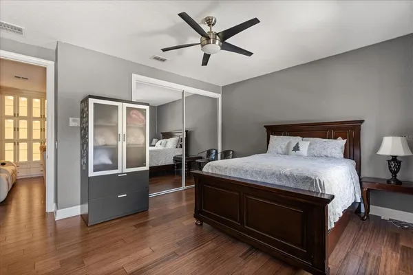 a bedroom with bed and a large mirror