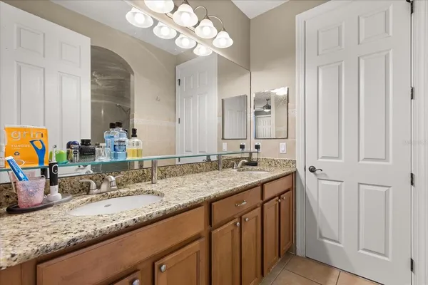 a view of a big yard with table and chairs under an umbrella