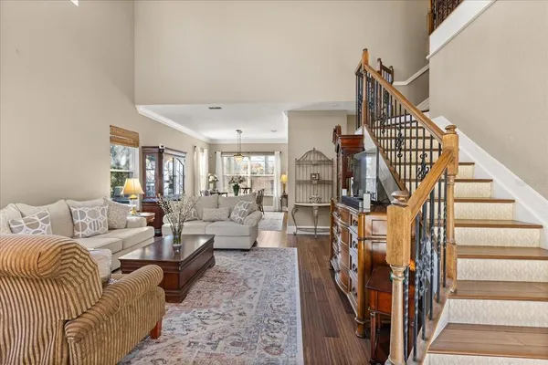 a living room with furniture or stairs and a wooden floor