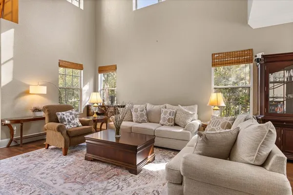 a living room with furniture and a wooden floor