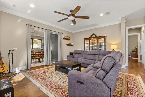 a living room with furniture a flat screen tv and a large window