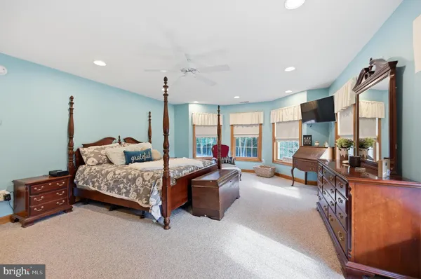 a bed room with furniture and a large window