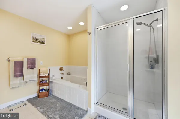 a bathroom with a bathtub shower and a sink
