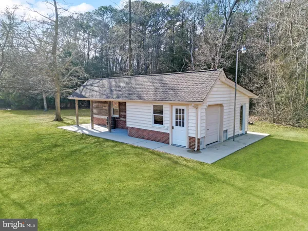 a view of a house with a yard and sitting area