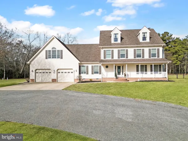 a view of a big house with a yard and plants