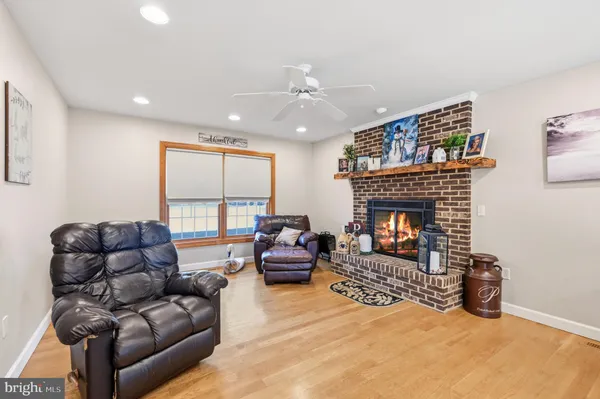 a living room with furniture a large window and a fireplace