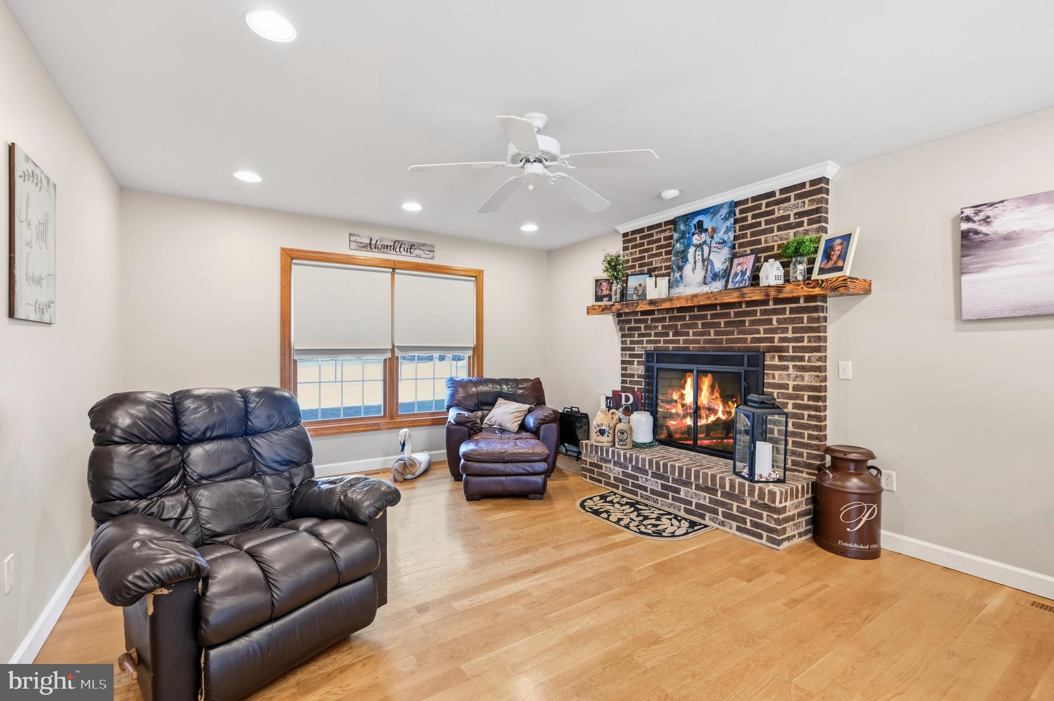 18981 Kenney Road Delmar, DE 19940 - Photo 7 of 31 a living room with furniture a large window and a fireplace