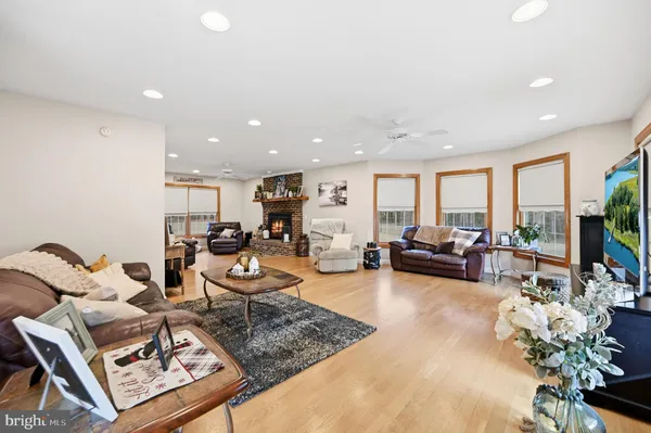 a living room with furniture potted plant and a large window