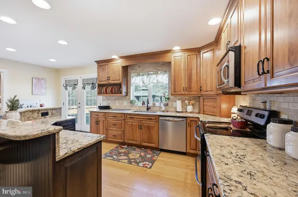 a kitchen with granite countertop lots of counter top space and stainless steel appliances