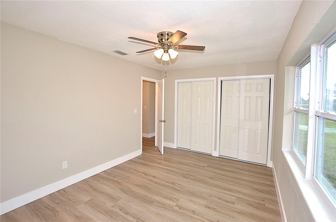 355 6th Road Southwest Vero Beach, FL 32962 - Photo 17 of 23 a view of empty room with wooden floor and fan