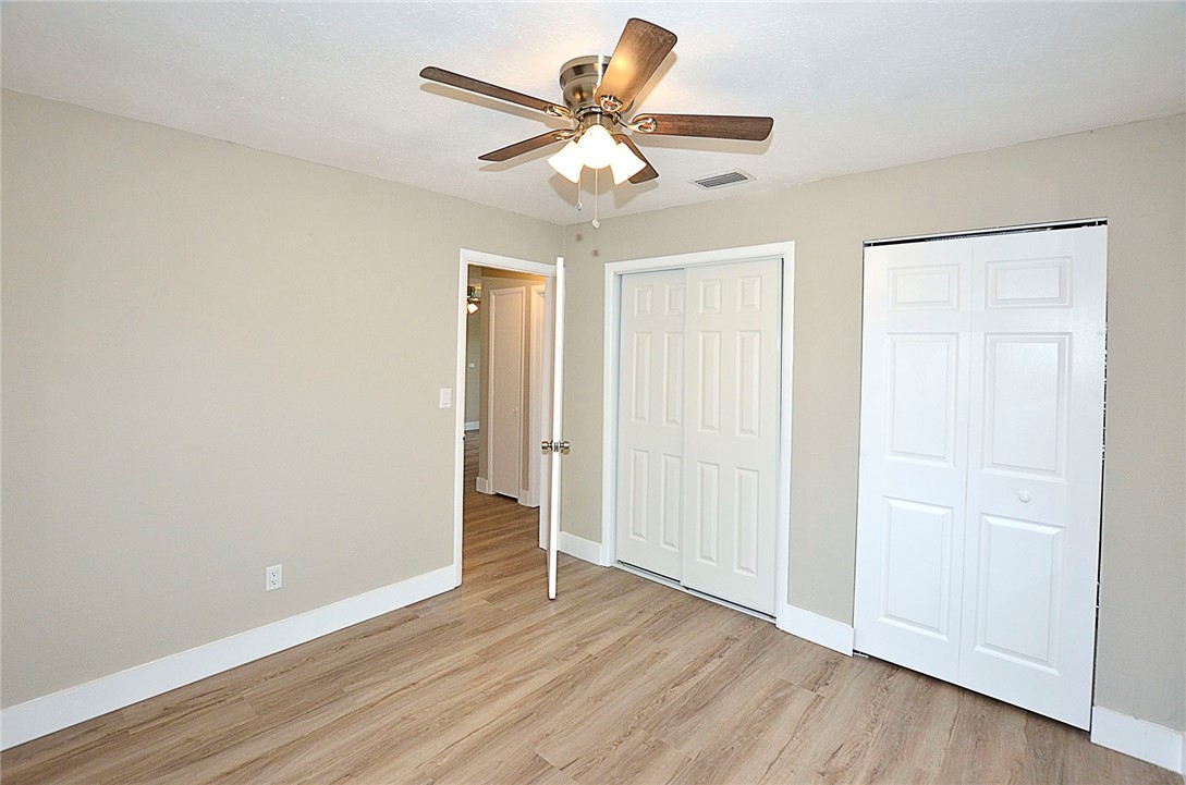 355 6th Road Southwest Vero Beach, FL 32962 - Photo 19 of 23 an empty room with wooden floor and ceiling fan