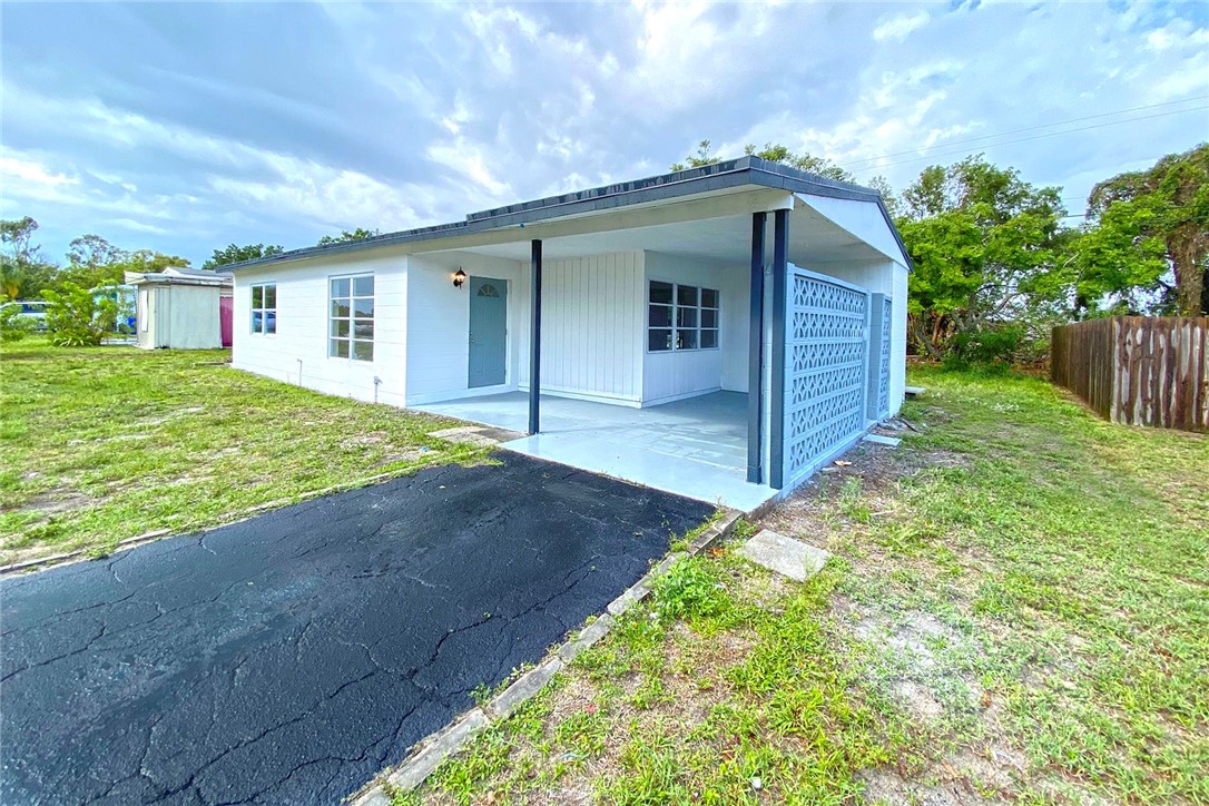 355 6th Road Southwest Vero Beach, FL 32962 - Photo 3 of 23 a front view of house with yard and trees